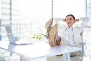 Relaxed businesswoman sitting with her feet up