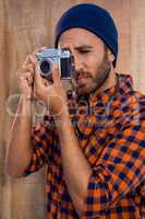 Hipster businessman photographing through camera