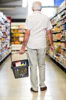 Rear view of senior man holding basket