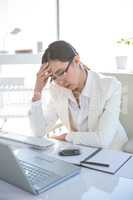 Stressed businesswoman working at her desk