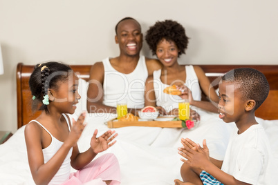 Happy family lying in bed together