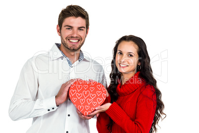 Couple holding heart shaped gift box