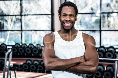 Muscular man posing with crossed arms