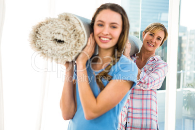 Mother and daughter holding a carpet