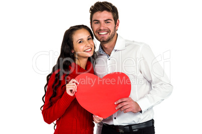 Happy couple holding paper heart