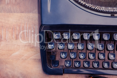 Old typewriter on wooden desk