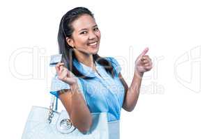 Smiling woman with a credit card in hand