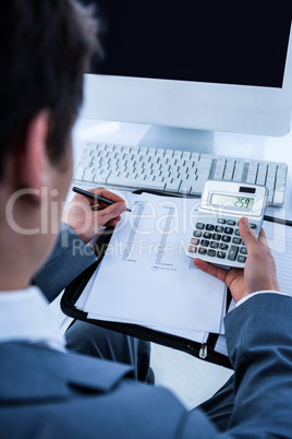 Businessman using his calculator