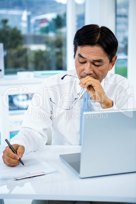 Asian businessman making notes
