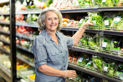 Senior woman picking out some vegetables