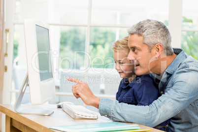 Father and son using the computer