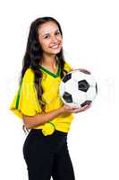 Attractive supporting woman holding football