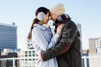 Affectionate couple against buildings