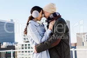 Affectionate couple against buildings