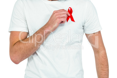 Midsection of man with red ribbon