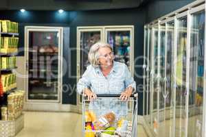 Smiling senior woman buying food