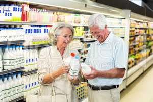 Senior couple buying milk