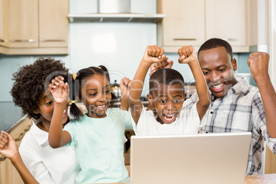 Happy family triumphing in the kitchen