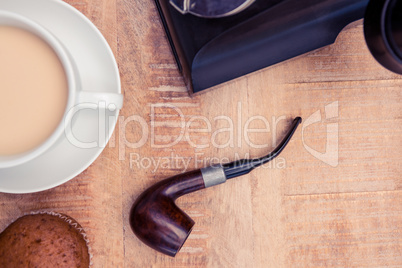 Close-up of coffee and smoking pipe