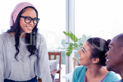 Colleagues looking at young businesswoman