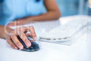 Cropped image of businesswoman using mouse