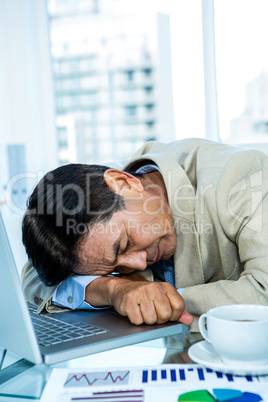 Tired asian businessman sleeping