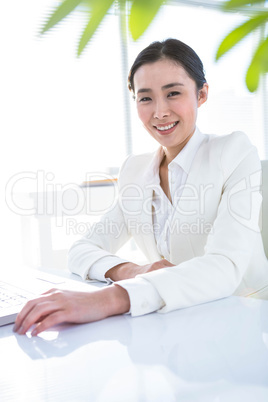 Smiling businesswoman with arms crossed