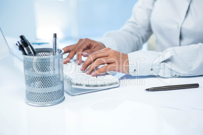 Businesswomans hands typing on computer keyboard