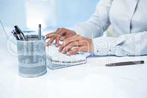 Businesswomans hands typing on computer keyboard