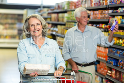 Smiling senior couple buying food