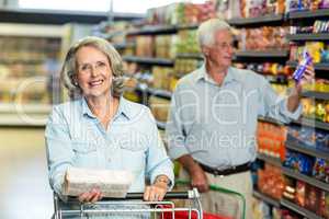 Smiling senior couple buying food