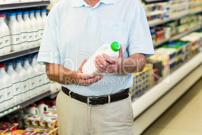 Senior man buying milk