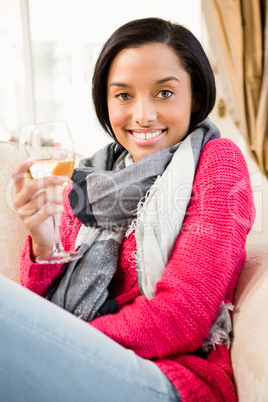 Smiling brunette holding a glass of white wine