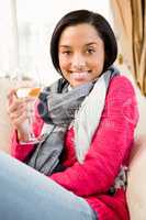 Smiling brunette holding a glass of white wine