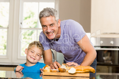 Happy father slicing bread