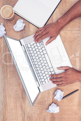 Cropped image of stressed businessman using laptop