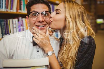 Nerd getting kissed by pretty girl