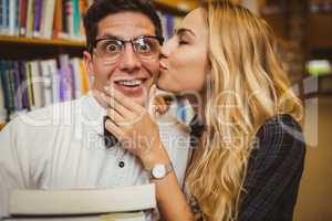 Nerd getting kissed by pretty girl