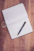 Overhead view of pen on open book