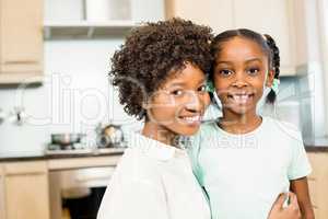 Mother and daughter smiling in the kitchen