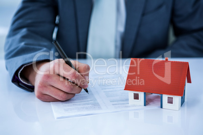 Businessman signing contract for new house