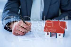 Businessman signing contract for new house