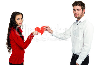 Portrait of couple holding red cracked heart shape