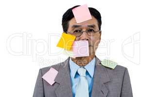 Businessman with blank note over his face