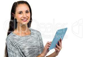 Smiling woman using digital tablet