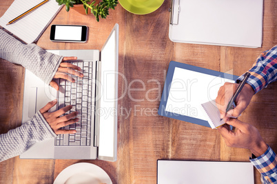 Cropped image of hands working at desk