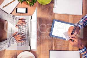 Cropped image of hands working at desk