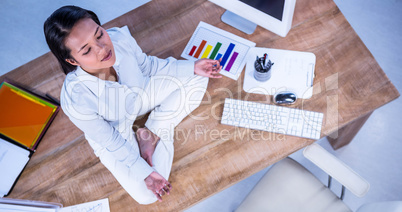 Peaceful businesswoman doing yoga sitting on floor