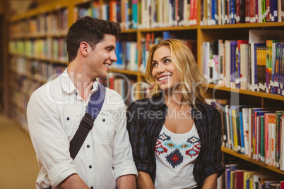 Couple with books looking at each other