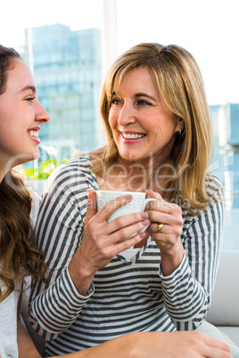 Mother and daughter drink tea